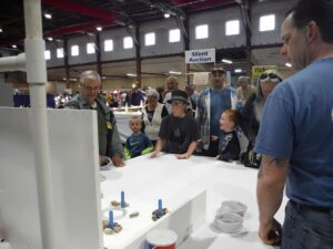 People playing tabletop game at a fair.