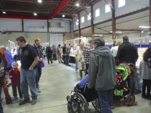 People walking in a large indoor market.
