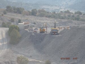 Construction site with heavy machinery and landscape.