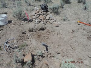 Desert excavation site with tools and rocks.