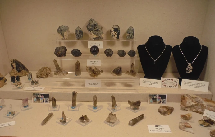 Gemstone and mineral display with necklaces.