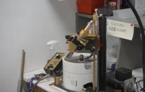 Gemstone faceting machine on a workbench.