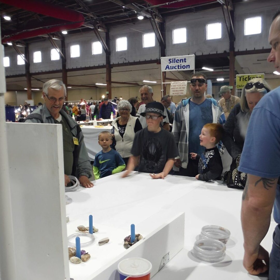 People playing tabletop game at a fair.